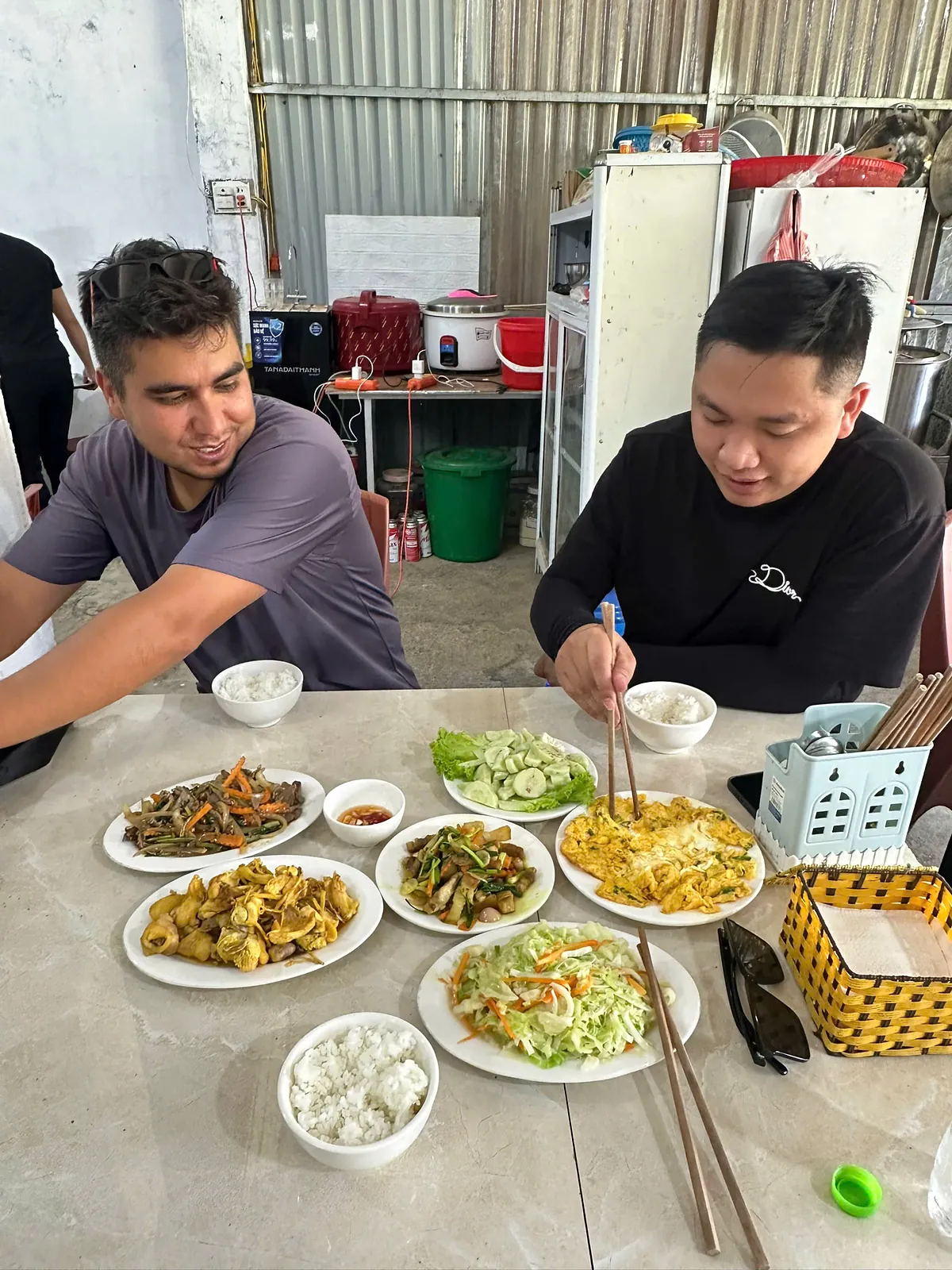 Lunch at a roadside family kitchen on the Loop: fresh vegetables, eggs and pork with rice