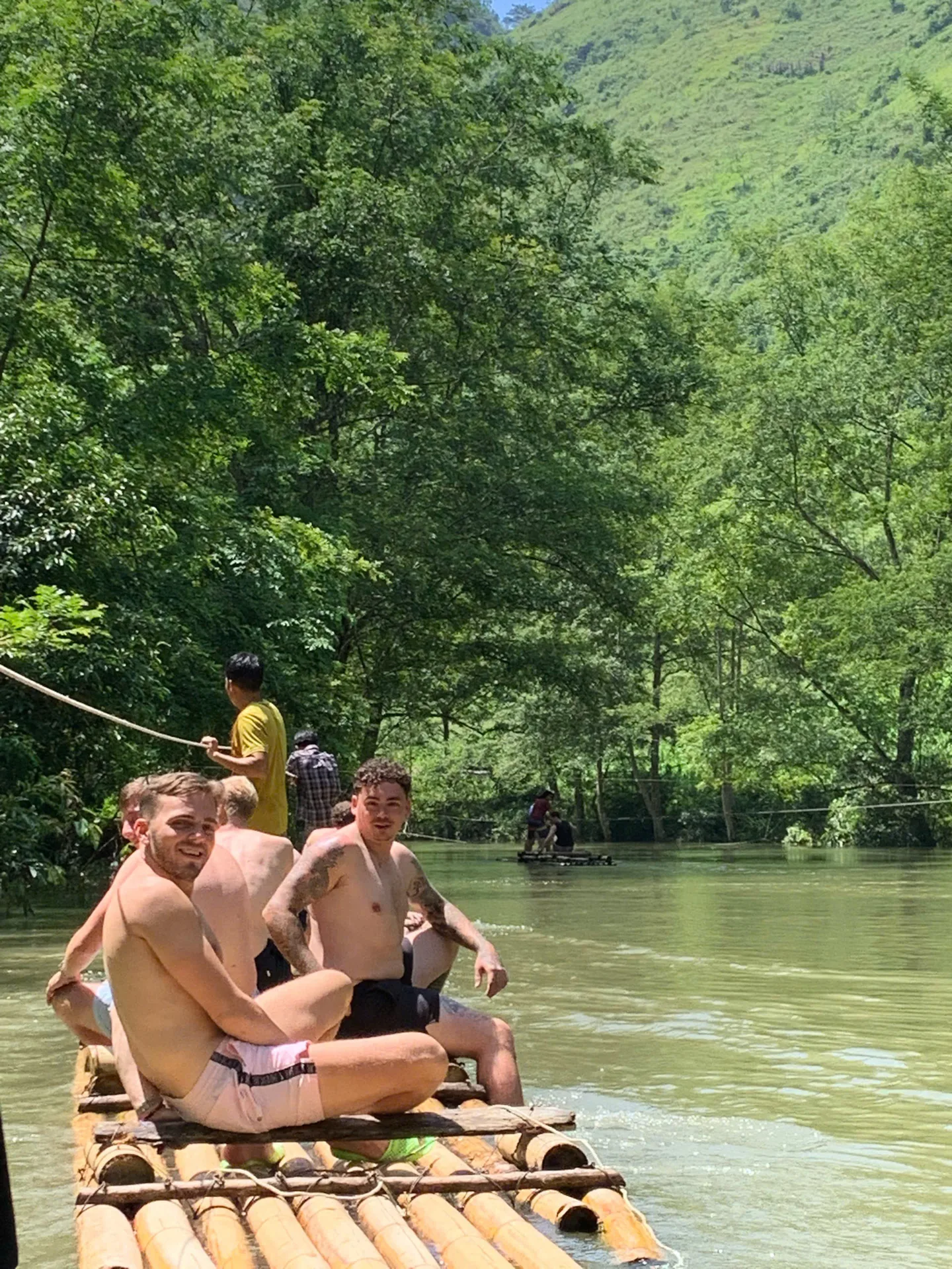 A bamboo raft drifting down the river