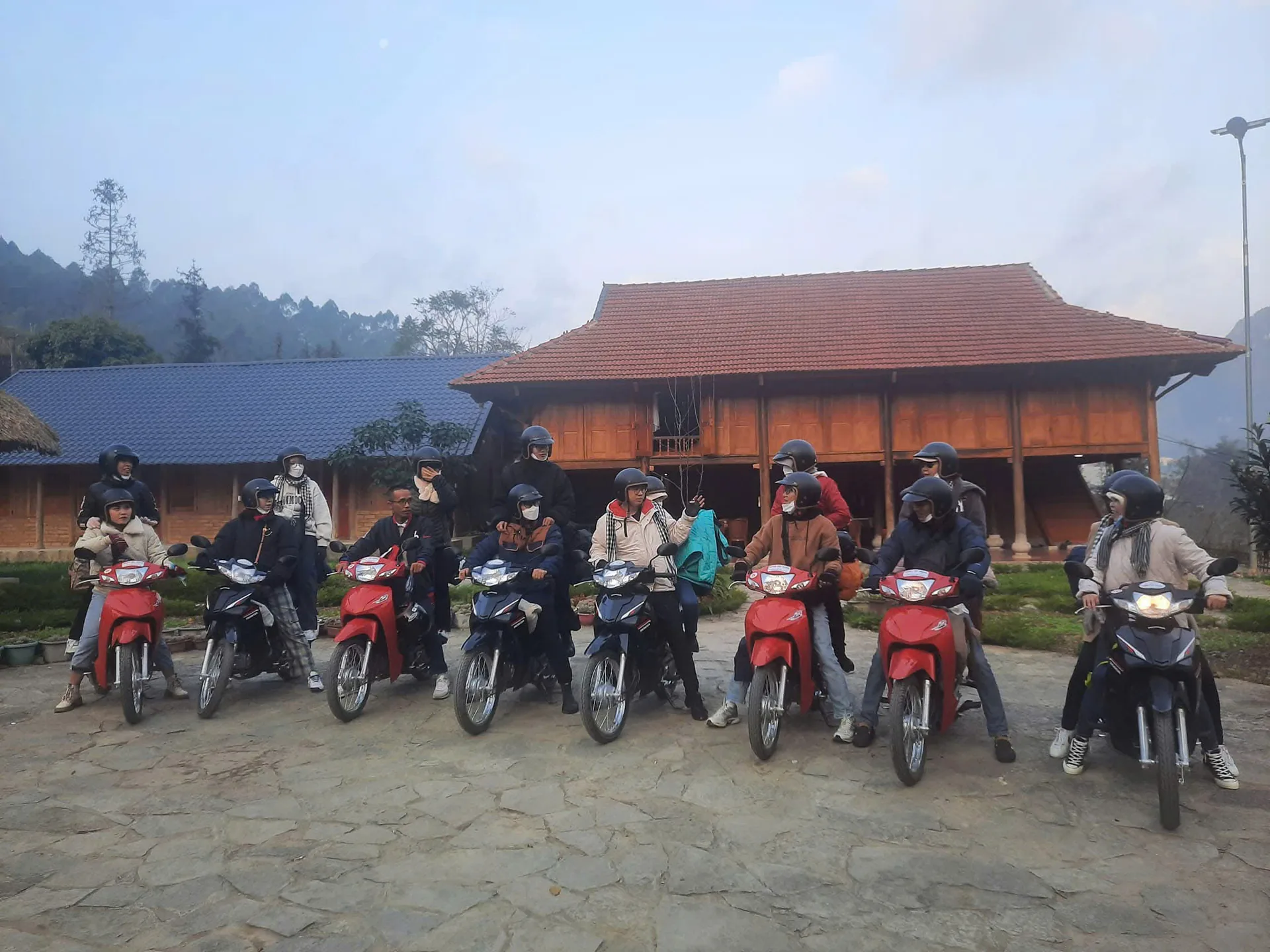 Riders resting outside a village house on the Loop