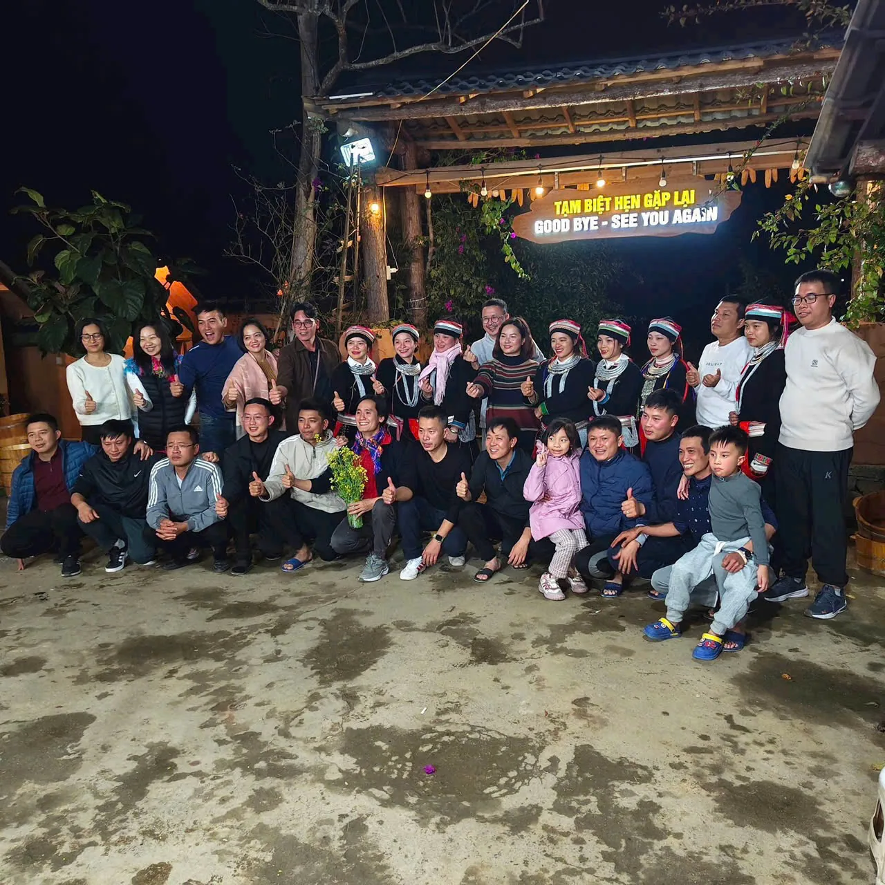 A group saying goodbye at the homestay gate